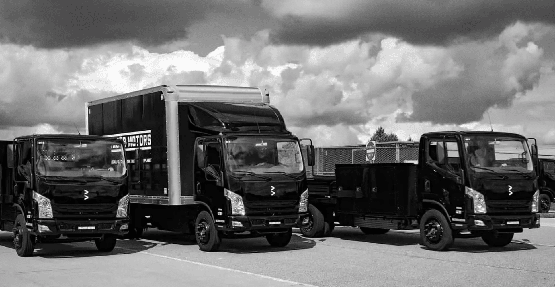 Three Bollinger B4 trucks with box and service bodies