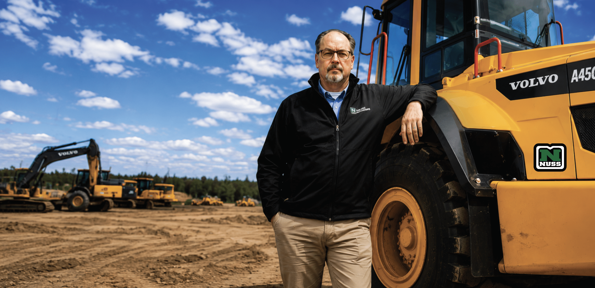 Randy Schroeder, Enterprise CE Customer Success Manager, leaning on a Volvo A45G articulated hauler